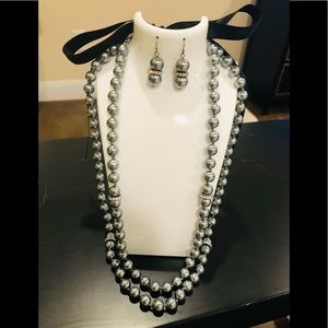 Double strand metallic grey bead necklace with black ribbon tie/earring set.
